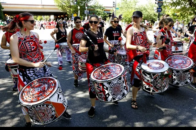 The Batala AFro Brazilian all women’s drum group marches inThe Capitol Hill Community 4th of July Parade, in Washington DC. (Photo by Robb Hill for The Washington Post)