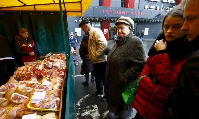 People look at pork at a street market during a food fair in Minsk, Belarus December 19, 2015. (Photo by Vasily Fedosenko/Reuters)