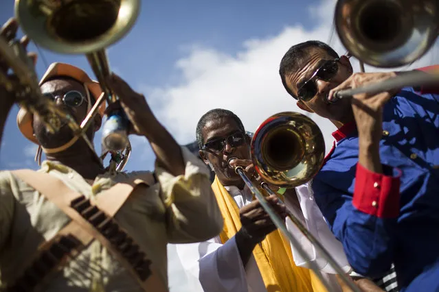 Revelers play the trumpet during the “Ceu na Terra”, or Heaven on earth, carnival parade in Rio de Janeiro, Brazil, Saturday, February 7, 2015. (Photo by Felipe Dana/AP Photo)