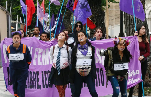 Members of feminist organisations take part in a rally against gender violence on the International Day for the Elimination of Violence Against Women, in Valparaiso, Chile, November 25, 2016. The placards on their bodies read: (L-R) “Woman exploited and underpaid”;  “I am lesbian”; and  “If I travel alone they murder me”. (Photo by Rodrigo Garrido/Reuters)