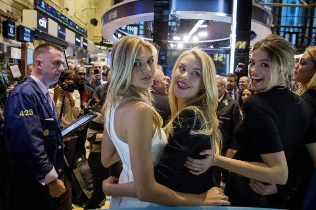 Sports Illustrated swimsuit models Kelly Rohrbach, Ashley Smith (2nd R), and Hailey Clauson (R) pose together on the floor of the New York Stock Exchange, February 6, 2015. (Photo by Brendan McDermid/Reuters)