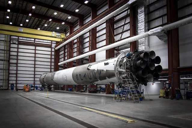 In this Sunday, January 3, 2016, photo, provided by SpaceX, the used Falcon 9 first stage rocket is seen in a hangar at Cape Canaveral, Fla. This represents SpaceX's first successful fly back and landing of a rocket booster. This leftover booster returned to land, following liftoff on a satellite-delivery mission, on December 21, 2015. (Photo by SpaceX via AP Photo)