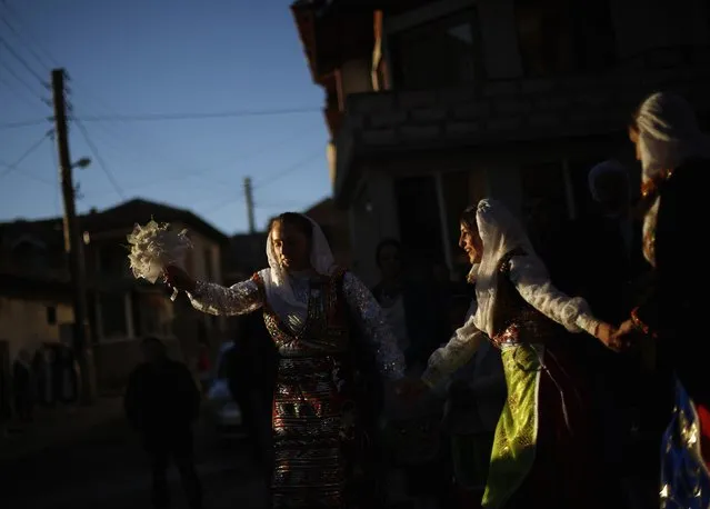 Women dance during the wedding ceremony of Bulgarian Muslims Fikrie Bindzheva and Azim Liumankov in the village of Ribnovo, in the Rhodope Mountains, February 14, 2015. (Photo by Stoyan Nenov/Reuters)