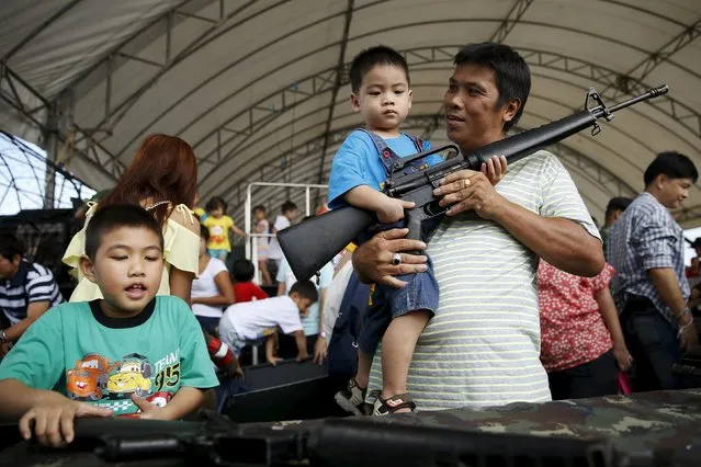 Children play with weapons during the Children's Day celebration at a military facility in Bangkok, Thailand January 9, 2016. (Photo by Jorge Silva/Reuters)