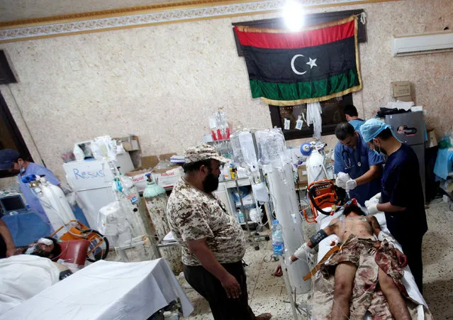 A wounded fighter from Libyan forces allied with the U.N.-backed government, who was injured during a battle with Islamic State fighters, receives treatment in a field hospital in Sirte, Libya August 16, 2016. (Photo by Ismail Zitouny/Reuters)