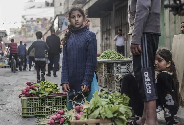 Palestinian children sell vegetables at the Zawia market in Gaza City on April 29, 2021. (Photo by Mahmoud Issa/SOPA Images/Rex Features/Shutterstock)