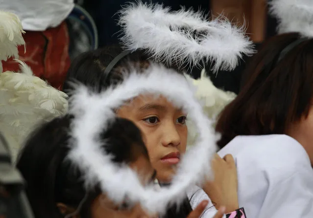 Filipino girls dressed as angels perform during a Christmas-theme street play to protest alleged extra judicial killings in Manila, Philippines on Wednesday, December 14, 2016. More than 5,000 people have been killed since President Rodrigo Duterte started his war on drugs campaign when he stepped into presidency last June 30. (Photo by Aaron Favila/AP Photo)