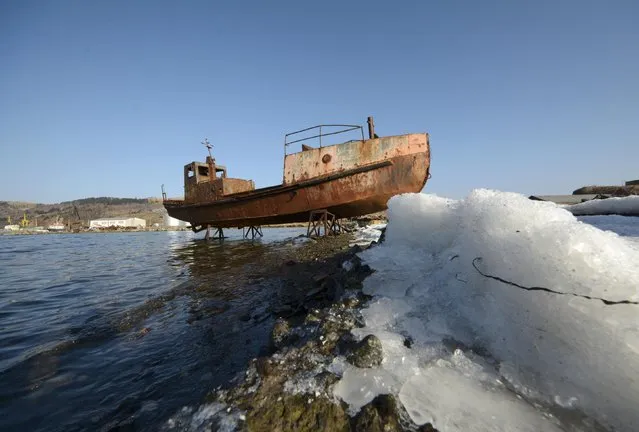 An abandoned motorboat is seen on the bank of a bay near Krabozavodskoye settlement on the Island of Shikotan, one of four islands known as the Southern Kuriles in Russia and the Northern Territories in Japan, December 19, 2016. (Photo by Yuri Maltsev/Reuters)