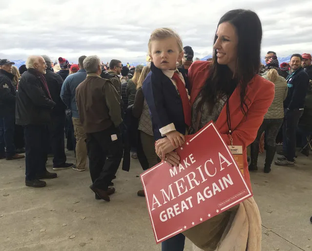 Jackie Poulsen of Billings, Montana, dressed her 15-month-old daughter Finley as Donald Trump for the president's rally in Belgrade, Mont., on Saturday, November 3, 2018. (Photo by Matt Volz/AP Photo)