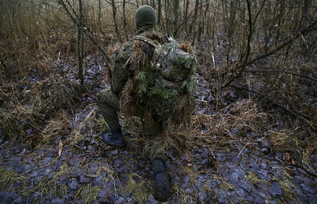 A man takes part in a territorial defence training organised by paramilitary group SJS Strzelec (Shooters Association) in the forest near Minsk Mazowiecki, eastern Poland March 14, 2014. (Photo by Kacper Pempel/Reuters)