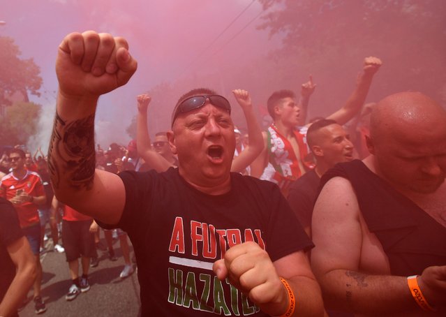 Hungary supporters and football fans burns smoke bombs as they march from Hero Square to the Puskas Arena in Budapest, Hungary on June 19, 2021 ahead of the UEFA EURO 2020 Group F football match between Hungary and France. (Photo by Marton Monus/Reuters)