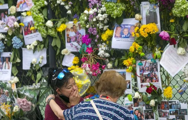 Mourners visit the makeshift memorial near the site of the collapsed condominium in Surfside, Florida on Tuesday, June 29, 2021. (Photo by Matias J. Ocner/AP Photo)