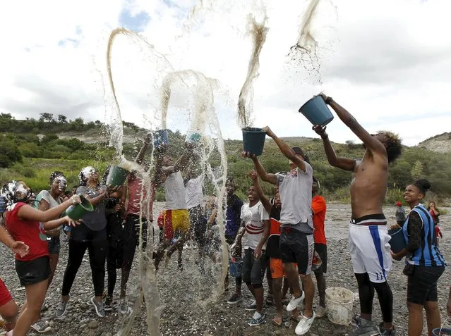 Revellers celebrate with water at the Chota river during a carnival festivity in Coangue, February 8, 2016. (Photo by Guillermo Granja/Reuters)