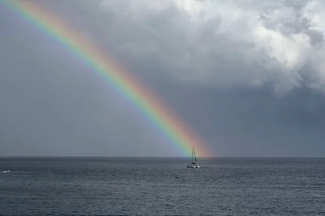 A rainbow appears after a heavy rainfall as a catamaran sails in Adriatic sea, seen from the town of Bol at the island of Brac, Croatia on August 30, 2023. (Photo by Marko Djurica/Reuters)