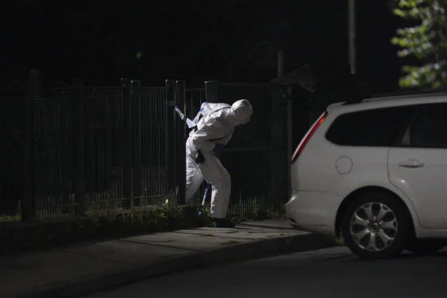 An officer in a forensics suit near the scene of an incident in the Keyham area of Plymouth, southwest England, Thursday, August 12, 2021. Police in southwest England said several people were killed, including the suspected shooter, in the city of Plymouth Thursday in a “serious firearms incident” that wasn't terror-related. (Photo by Ben Birchall/PA Wire via AP Photo)
