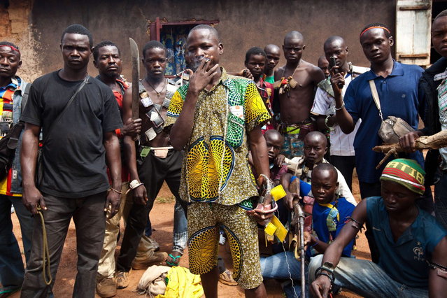 Anti-Balaka fighters, members of a militia opposed to the Seleka rebel group, pose with weapons and amulets in a village in the Boy-Rabe neighborhood in Bangui on December 14, 2013. (Photo by Ivan Lieman/AFP Photo)