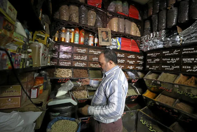 A worker at herbal store, takes ingredients to prepare natural herbal drug in Cairo, Egypt January 10, 2017. (Photo by Mohamed Abd El Ghany/Reuters)