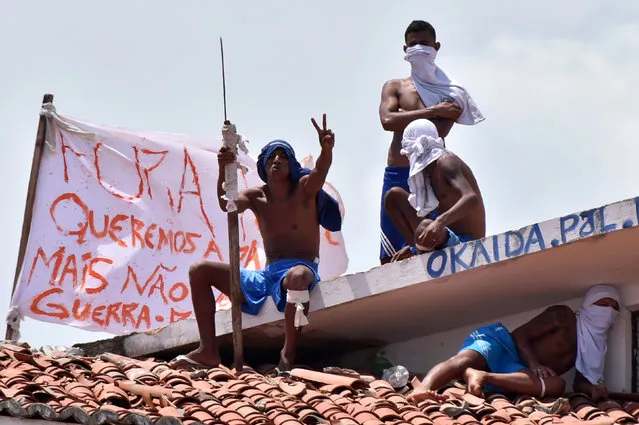 Inmates are seen on a roof during an uprising at Alcacuz prison in Natal, Rio Grande do Norte state, Brazil, January 17, 2017. (Photo by Josemar Goncalves/Reuters)