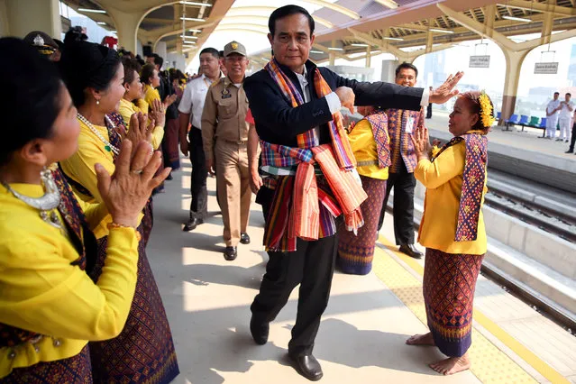 Thailand's Prime Minister Prayuth Chan-ocha performs a traditional dance with performers at Khon Kaen railway station during a visit ahead of the general election in Khon Kaen Province, Thailand, March 13, 2019. (Photo by Athit Perawongmetha/Reuters)