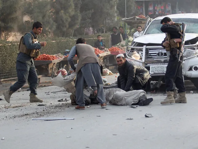 Afghan men try to carry an injured man after a bomb blast in Jalalabad, Afghanistan February 1, 2017. (Photo by Reuters/Parwiz)