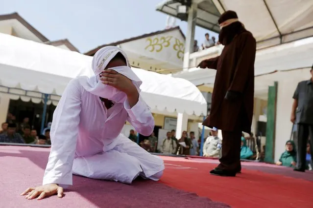 An Acehnese woman collapses after being whipped in front of the public for violating sharia law in Banda Aceh, Indonesia, 02 February 2017. (Photo by Hotli Simanjuntak/EPA)