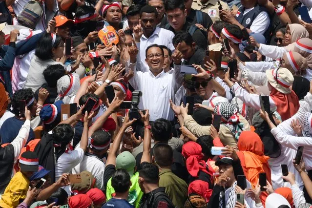 Presidential and vice presidential candidates, Anies Baswedan (C) and Muhaimin Iskandar (back C), greet their supporters during their campaign rally at the Jakarta International Stadium, in Jakarta on February 10, 2024. (Photo by Bay Ismoyo/AFP Photo)