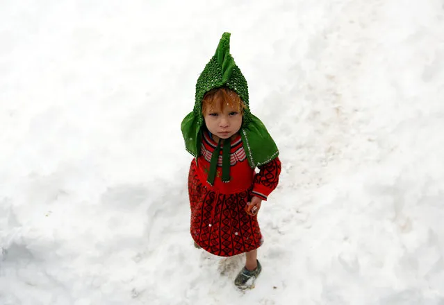 An Internally displaced Afghan child stands outside her shelter during a snowfall in Kabul, Afghanistan February  5, 2017. (Photo by Mohammad Ismail/Reuters)