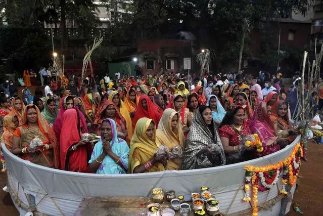 Hindu women perform rituals standing in a makeshift pond during Chhath festival in Mumbai, India, Wednesday, November 10, 2021. (Photo by Ajit Solanki/AP Photo)