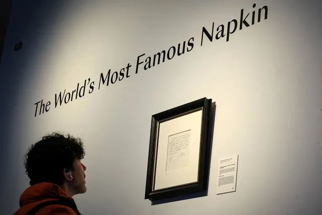 A guest looks at a napkin written on by Carles Rexach, Barcelona's former sporting director, on December 14, 2000, promising a contract to secure 13-year-old Lionel Messi for FC Barcelona, on display at Bonhams Auctions in New York City, on March 6, 2024. (Photo by Brendan McDermid/Reuters)