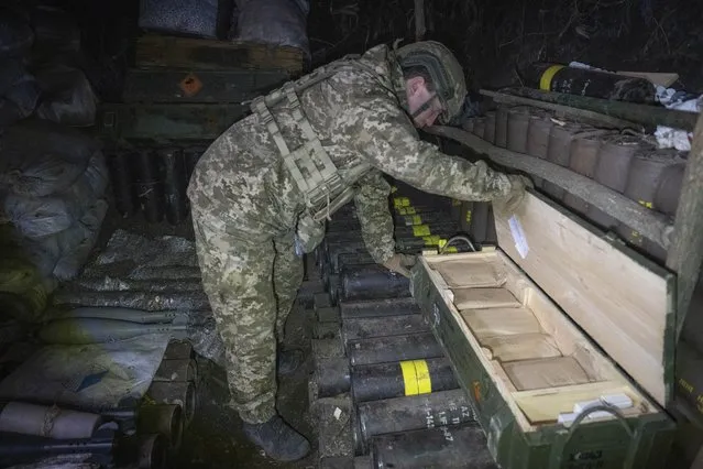 A Ukrainian serviceman of the 28th Separate Mechanised Brigade checks ammunitions in a trench at the front line, near Bakhmut, Donetsk region, Ukraine, Sunday, March 3, 2024. (Photo by Efrem Lukatsky/AP Photo)