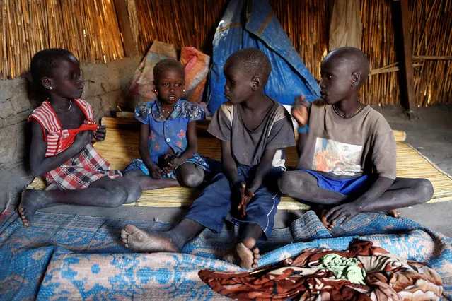 Nyameer Mario, 6, Nyawan Mario, 4, Ruai Mario, 10 and Machiey Mario, 8 (L-R), talk at the South Sudan (UNMISS) Protection of Civilian site (CoP), near Bentiu, South Sudan, February 12, 2017. (Photo by Siegfried Modola/Reuters)