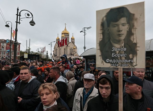 People attend a parade and the Immortal Regiment event on Victory Day in Vladivostok, Russia, on May 9, 2024. (Photo by Tatiana Meel/Reuters)