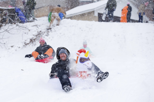 People sled during the snow storm at Ghent Hill Park Sunday, January 16, 2022, in Roanoke, Va. (Photo by Scott P. Yates/The Roanoke Times via AP Photo)