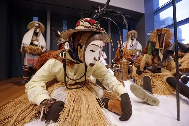 Nigerian masks from the 1950's are displayed with costumes to create a “masquerade parade” as part of the the show “Disguise: Masks & Global African Art” at the Seattle Art Museum, Sunday, June 28, 2015, in Seattle. Race, identity and the masks people wear are the themes explored in the new exhibit of contemporary, multimedia art, which showcases masks from the museum's collection alongside contemporary art, much of it created just for this show by African artists and those of African descent. (Photo by Elaine Thompson/AP Photo)