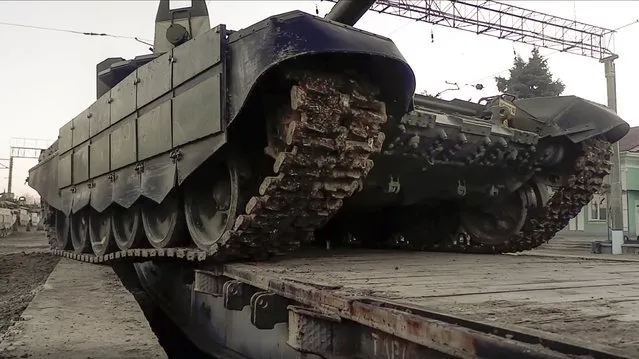 In this photo taken from video provided by the Russian Defense Ministry Press Service on Tuesday, February 15, 2022, a Russian tank is loaded onto railway platforms after the end of military drills in South Russia. (Photo by Russian Defense Ministry Press Service via AP Photo)