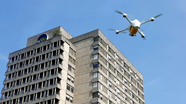 A Matternet M2 drone of U.S. manufacturer Matternet carrying a box containing laboratory samples flies during a presentation of Swiss Post and the Ticino EOC hospital group in front of the Ospedale Civico hospital in Lugano, Switzerland, March 31, 2017. (Photo by Arnd Wiegmann/Reuters)