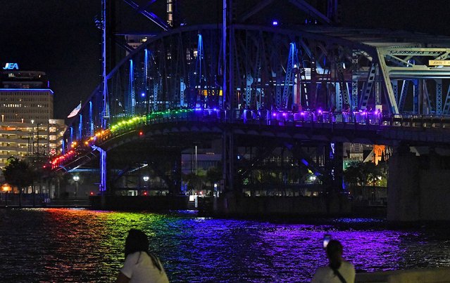 Supporters of Jacksonville, Florida's LGBTQ community organized a rainbow lighting of the city's Main Street Bridge on Friday, May 31, 2024. According to the Florida Times-Union, the lighting was in response to a state Department of Transportation decision to keep the nearby Acosta Bridge lit red, white and blue all summer. Acosta had rainbow lights the past three years for Pride Month. (Photo by Bob Self/Florida Times-Union/USA Today Network)