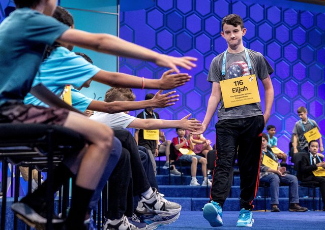Elijah Elledge, a 6th grader from Minnesota, gets support from fellow spellers as he exits the competition in the Scripps National Spelling Bee in National Harbor, Maryland, U.S., May 28, 2024. (Photo by Evelyn Hockstein/Reuters)