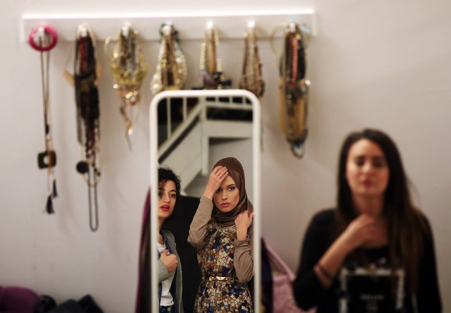Stylists help a model to get ready for a fashion photo-shoot for a leading online website that offers conservative fashion items, in Istanbul, Monday, May 9, 2016. Istanbul is hosting Turkey's first Modest Fashion Week, a two-day event that kicks off on May 13th and brings together designers of conservative wear from around the world. (Photo by Lefteris Pitarakis/AP Photo)