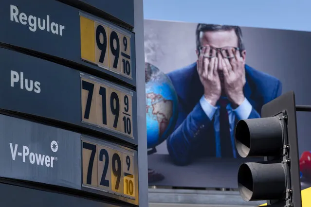 Gas prices are seen in front of a billboard advertising HBO’s Last Week Tonight in Los Angeles, Monday, March 7, 2022. The price of regular gasoline broke $4 per gallon on average across the U.S. on Sunday for the first time since 2008. (Photo by Jae C. Hong/AP Photo)