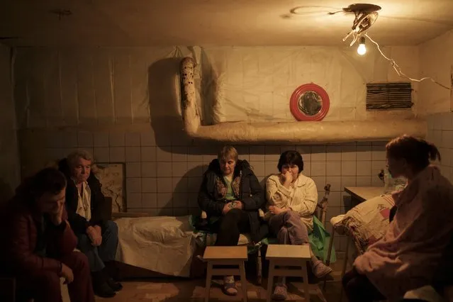 Hospital staff sit in a basement, used as a bomb shelter, during an air raid alarm in Brovary, north of Kyiv, Ukraine, Thursday, March 17, 2022. (Photo by Felipe Dana/AP Photo)