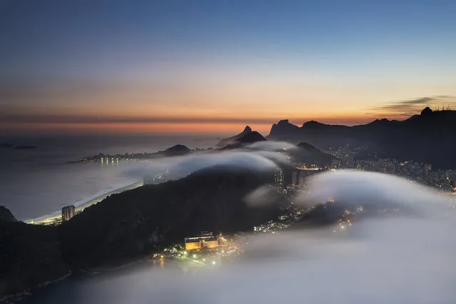 “Far above the clouds”. Rio de Janeiro viewed from above the clouds on Sugar Loaf Mountain. Photo location: Rio de Janeiro, Brazil. (Photo and caption by Tony Burns/National Geographic Photo Contest)