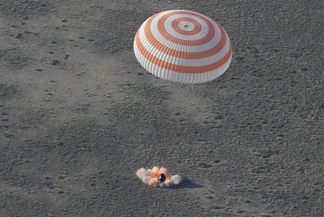 The Soyuz TMA-11M capsule with the International Space Station (ISS) crew members Japanese astronaut Koichi Wakata, Russian cosmonaut Mikhail Tyurin and U.S. astronaut Rick Mastracchio lands south-east of the town of Dzhezkazgan in central Kazakhstan, May 14, 2014. The first Japanese to command a space mission and crewmates from the United States and Russia landed safely in Kazakhstan on Wednesday, wrapping up a 188-day stay aboard the International Space Station. (Photo by Dmitry Lovetsky/Reuters)