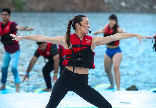 Up to 1,000 people took part in the first Dubai Stand-Up Paddle in Hatta on Saturday, November 18, 2023. There were two sunset yoga sessions, held on boards and run by expert instructors. (Photo by Victor Besa/The National)