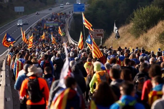 Some hundred Catalan pro-independence supporters attend a protest march from the town to Berga to Barcelona against the Spanish Supreme Court's sentences to pro-independence leaders, released last 14 October, in Catalonia, northeastern Spain, 16 October 2019. Some protest marches called “Marches for Freedom” are running from the five Catalan cities of Girona, Vic, Berga, Tarrega and Tarragona to arrive to Barcelona next 18 October. (Photo by Quique Garcia/EPA/EFE)