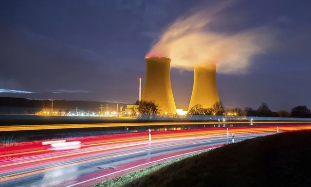 Steam rises from the cooling towers of the Grohnde nuclear power plant near Grohnde, Germany, Wednesday, December 29, 2021. Germany on Friday, Dec. 31, 2021 is shutting down half of the six nuclear plants it still has in operation, a year before the country draws the final curtain on its decades-long use of atomic power. (Photo by Julian Stratenschulte/dpa via AP Photo)
