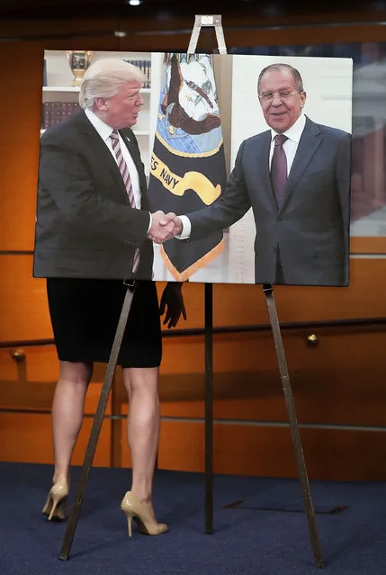 House Democrats display a photograph of President Donald Trump welcoming Russian Foreign Minister Sergey Lavrov to the White House during a news conference at the U.S. Capitol May 17, 2017 in Washington, DC. House Democrats have introduced legislation to create an outside, independent commission to investigate possible connections between President Donald Trump and Russian officials. If Speaker Paul Ryan (R-WI) does not support the legislation then Democrats said they will file a discharge petition to force a vote on the measure. (Photo by Chip Somodevilla/Getty Images)