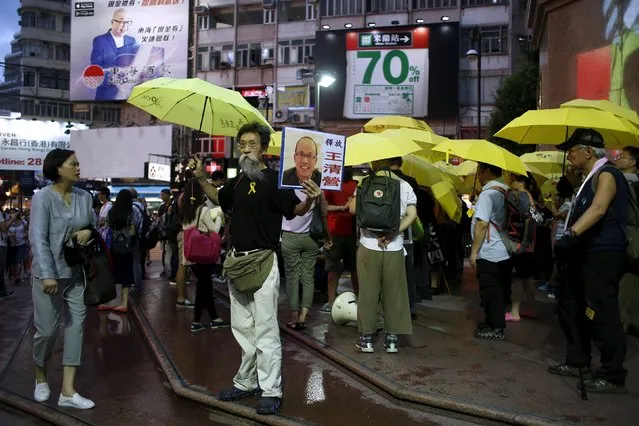 Pro-democracy protesters demanding the release of mainland activists they take part in a rally at a shopping district in Hong Kong, China July 23, 2015. A closely-watched trial of three Chinese rights activists resumed on Thursday in the southern Chinese city of Guangzhou, amid an unprecedented crackdown by authorities on human rights lawyers across the country. (Photo by Bobby Yip/Reuters)