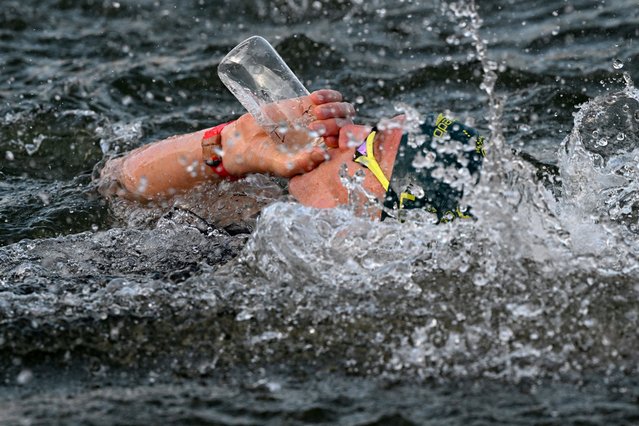 Australia's Kyle Lee drinks during the men's 10km marathon swimming final at the Paris 2024 Olympic Games at Pont Alexandre III in Paris on August 9, 2024. (Photo by Angelika Warmuth/Reuters)