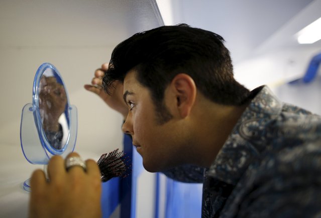 Elvis Presley tribute artist Richard Wolfe of Hamilton, Ontario prepares in a dressing room for a gospel talent contest during the four-day Collingwood Elvis Festival in Collingwood, Ontario July 26, 2015. (Photo by Chris Helgren/Reuters)
